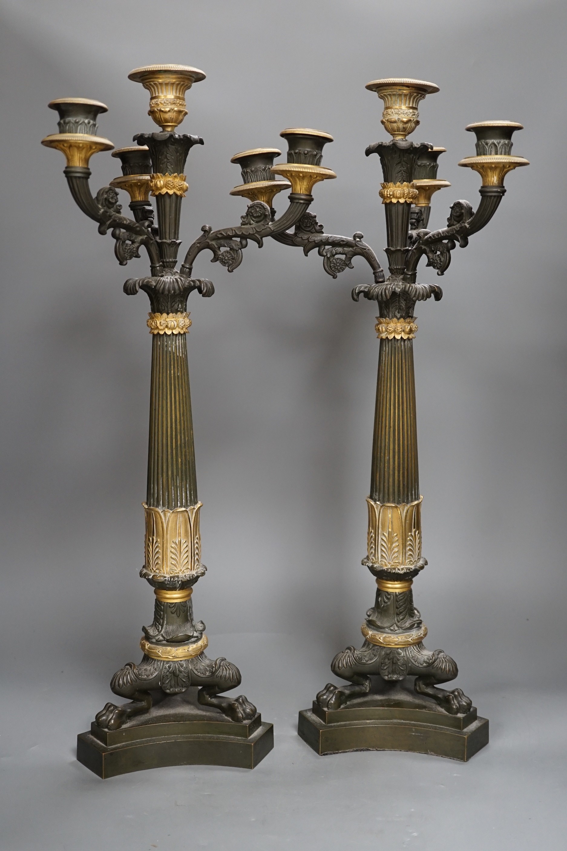 A pair of 19th century French Empire style bronze and gilt metal three branch, four light candelabra, 54cms high